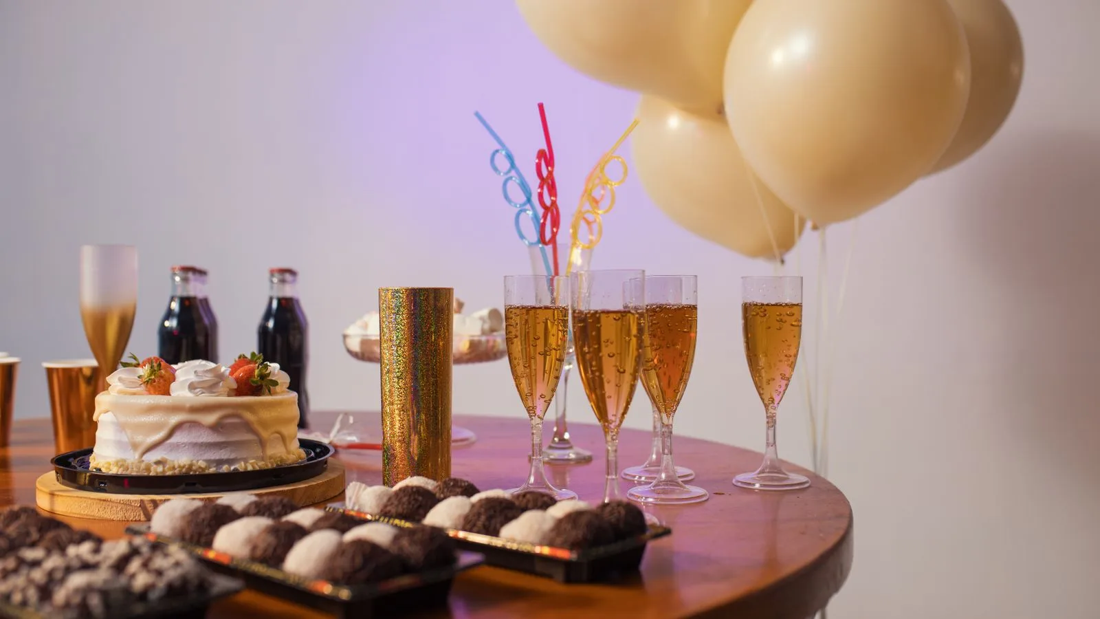 A festive Brazilian table setup with cake, drinks, sweets, and balloons, perfect for any celebration.