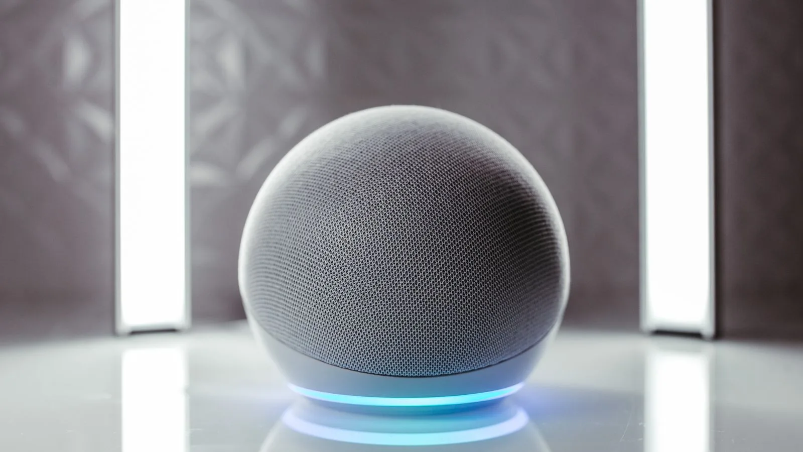 Close-up of a spherical smart speaker with illuminated base, perfect for modern interiors.