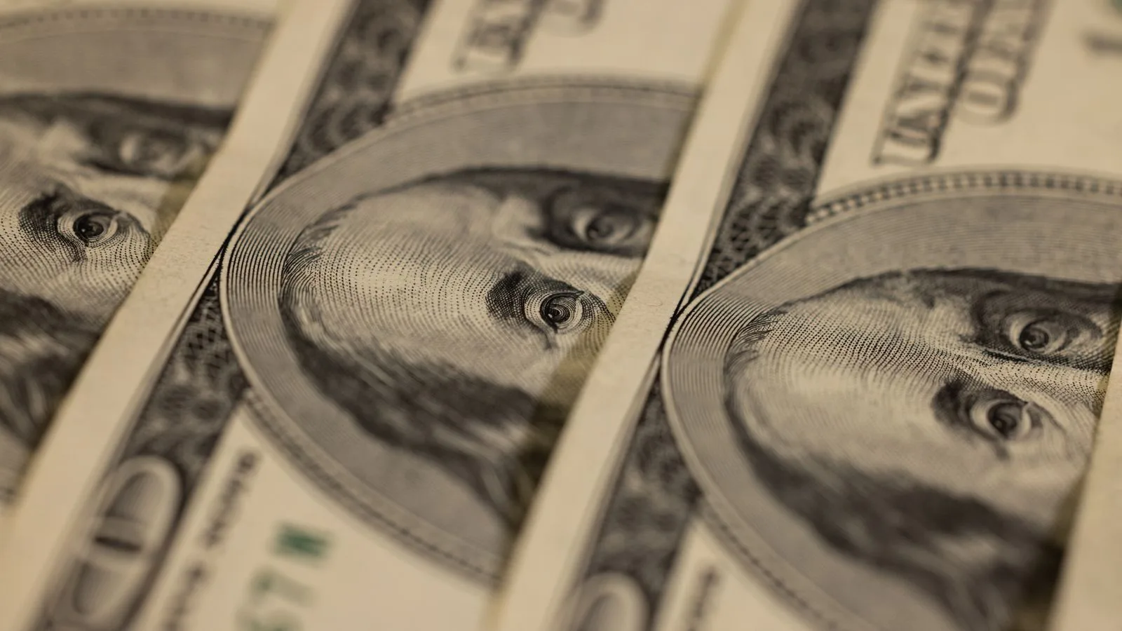 Detailed macro shot of multiple US dollar bills showcasing intricate currency design.