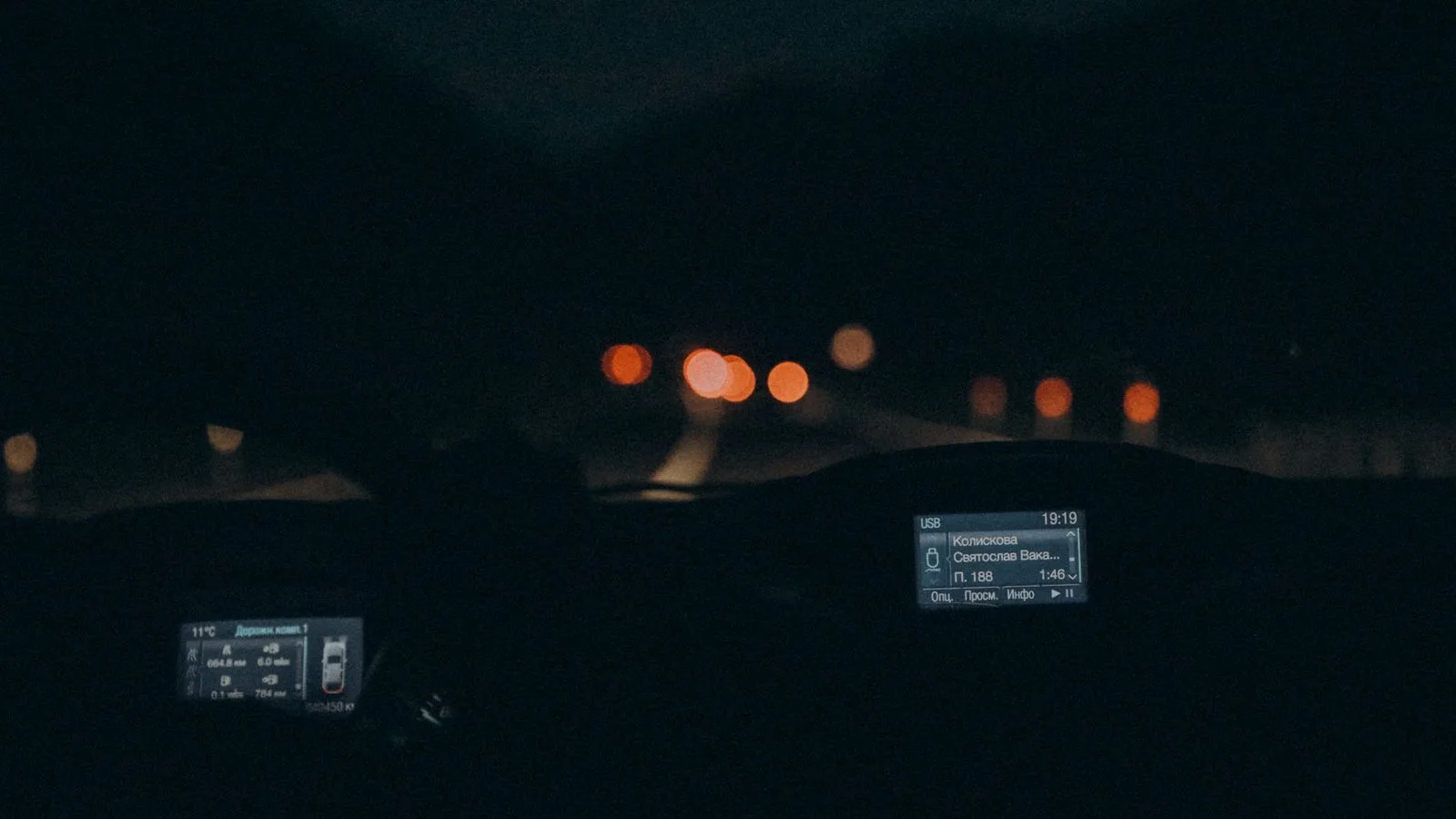 Experience the serene ambiance of night driving with this car interior view featuring a dimly lit dashboard.