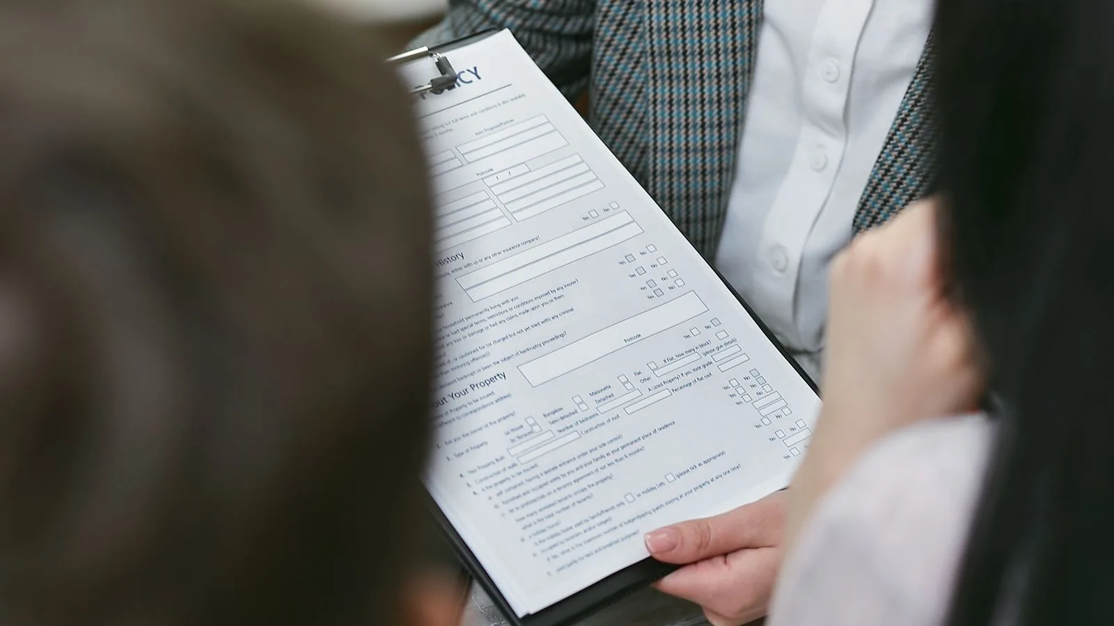 Close-up of professionals discussing a legal contract during a business meeting.