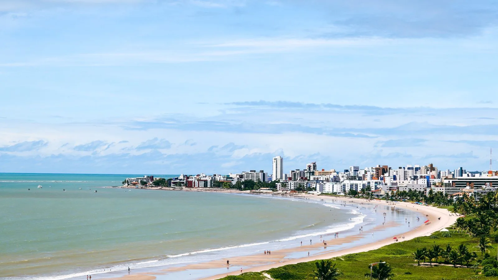 Stunning aerial shot of João Pessoa's beach and cityscape with clear blue skies.