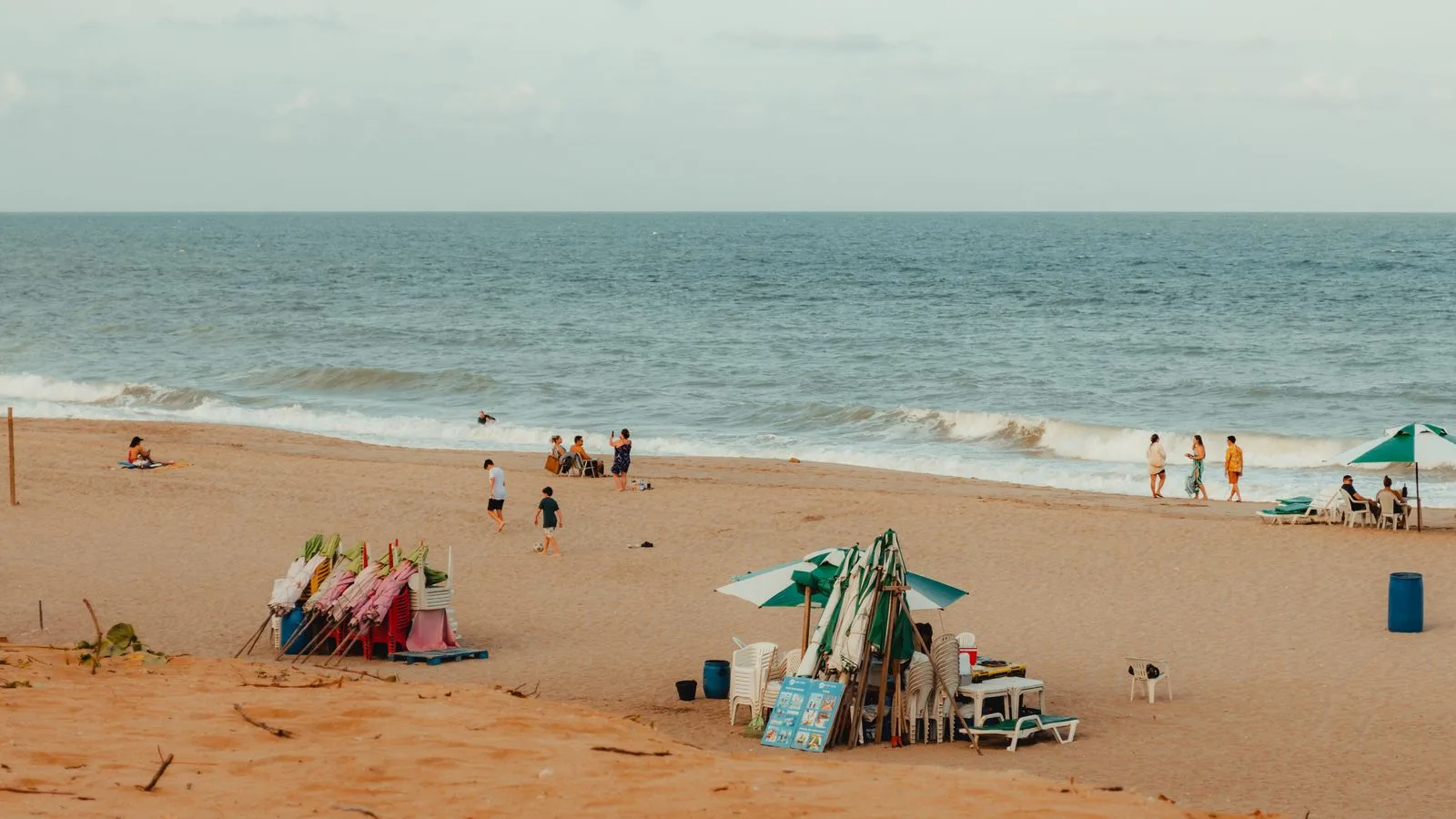 Relaxing beach scene with people enjoying a sunny day in RN, Brazil.