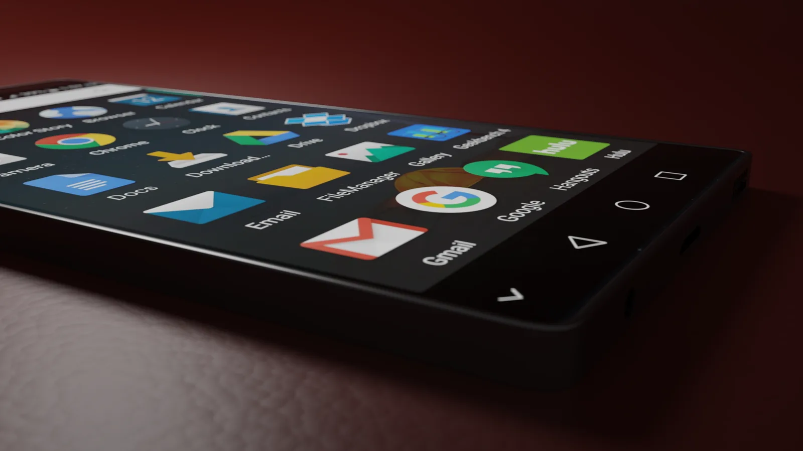 Close-up of a smartphone displaying various app icons in a low-light setting.