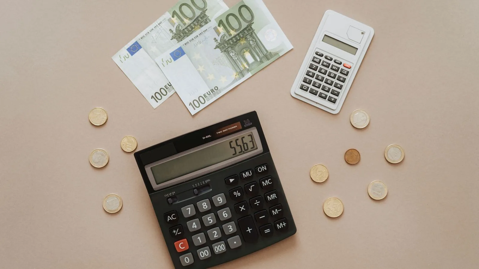 Flat lay of calculators and Euro currency, depicting financial calculations and budget management.