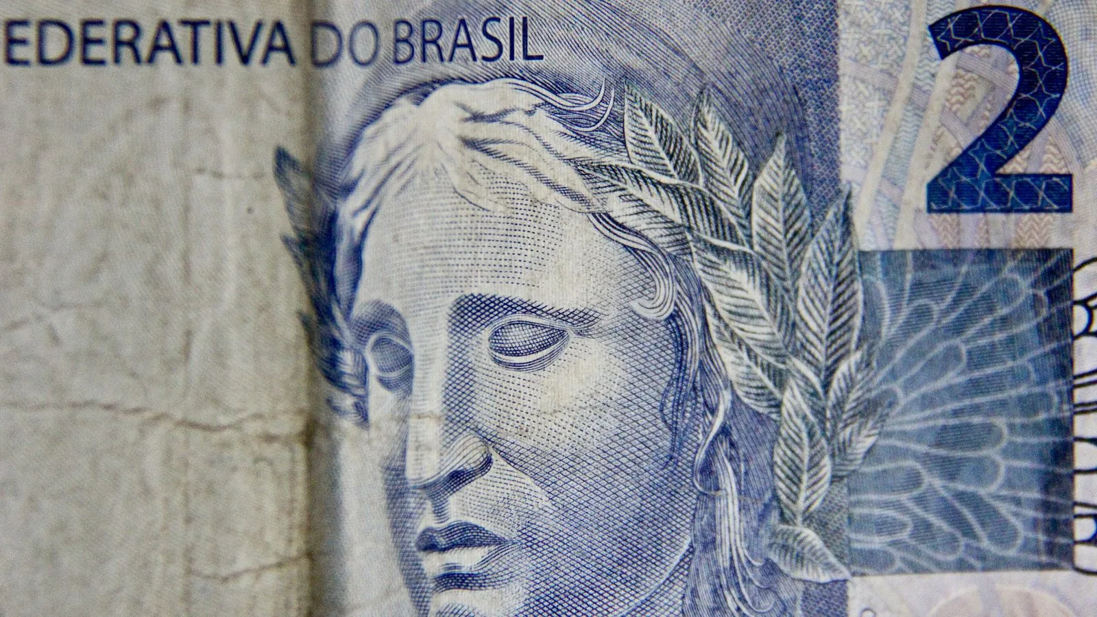 Detailed close-up of a Brazilian two real banknote emphasizing its artistic design.