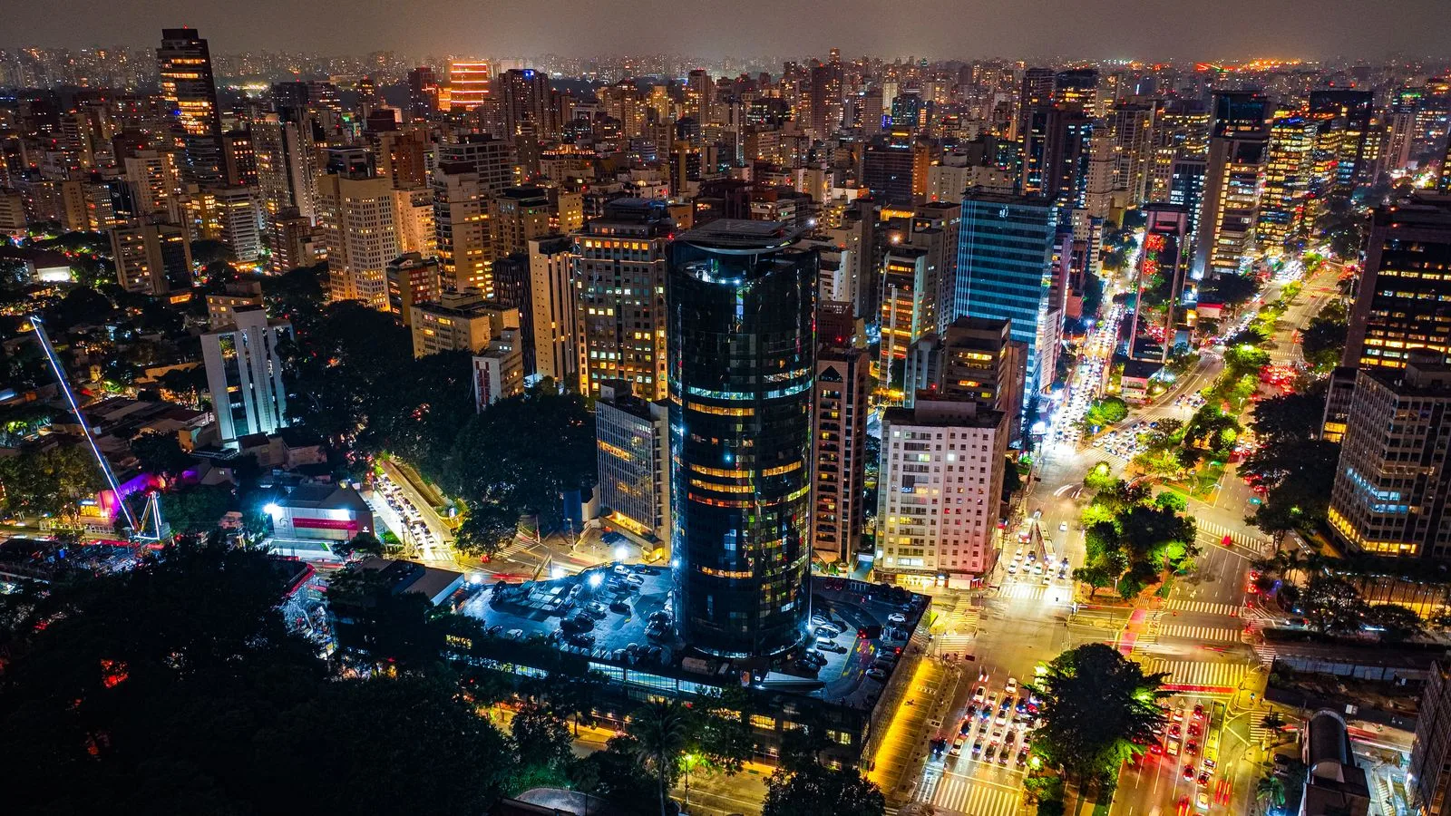 A breathtaking aerial night view of São Paulo's vibrant cityscape with illuminated skyscrapers.