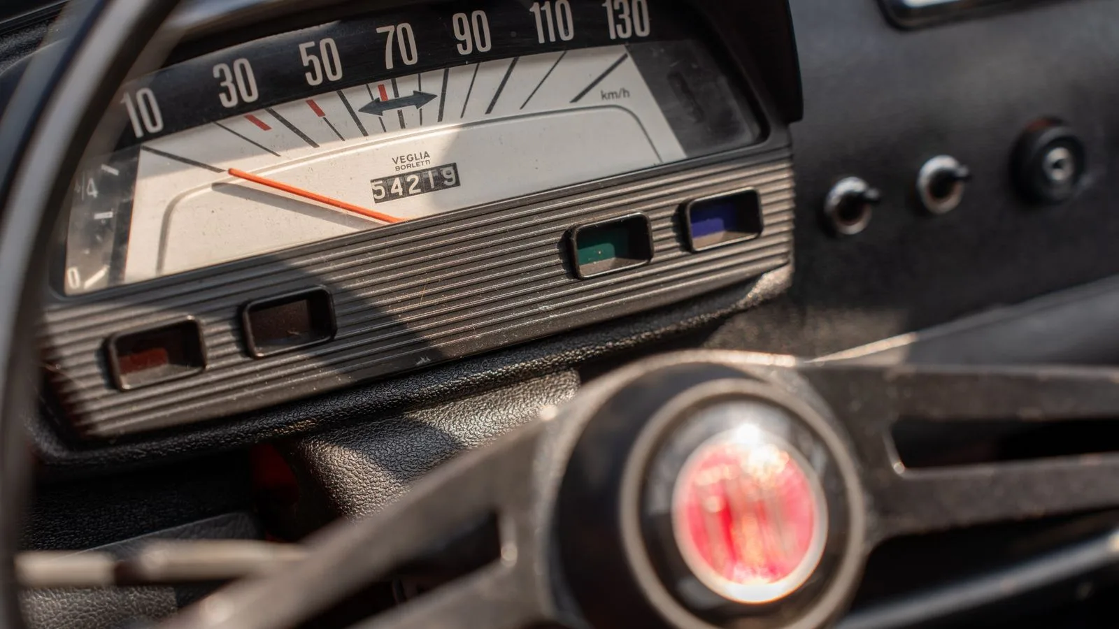 Close-up of a vintage car speedometer, showcasing classic dashboard design.