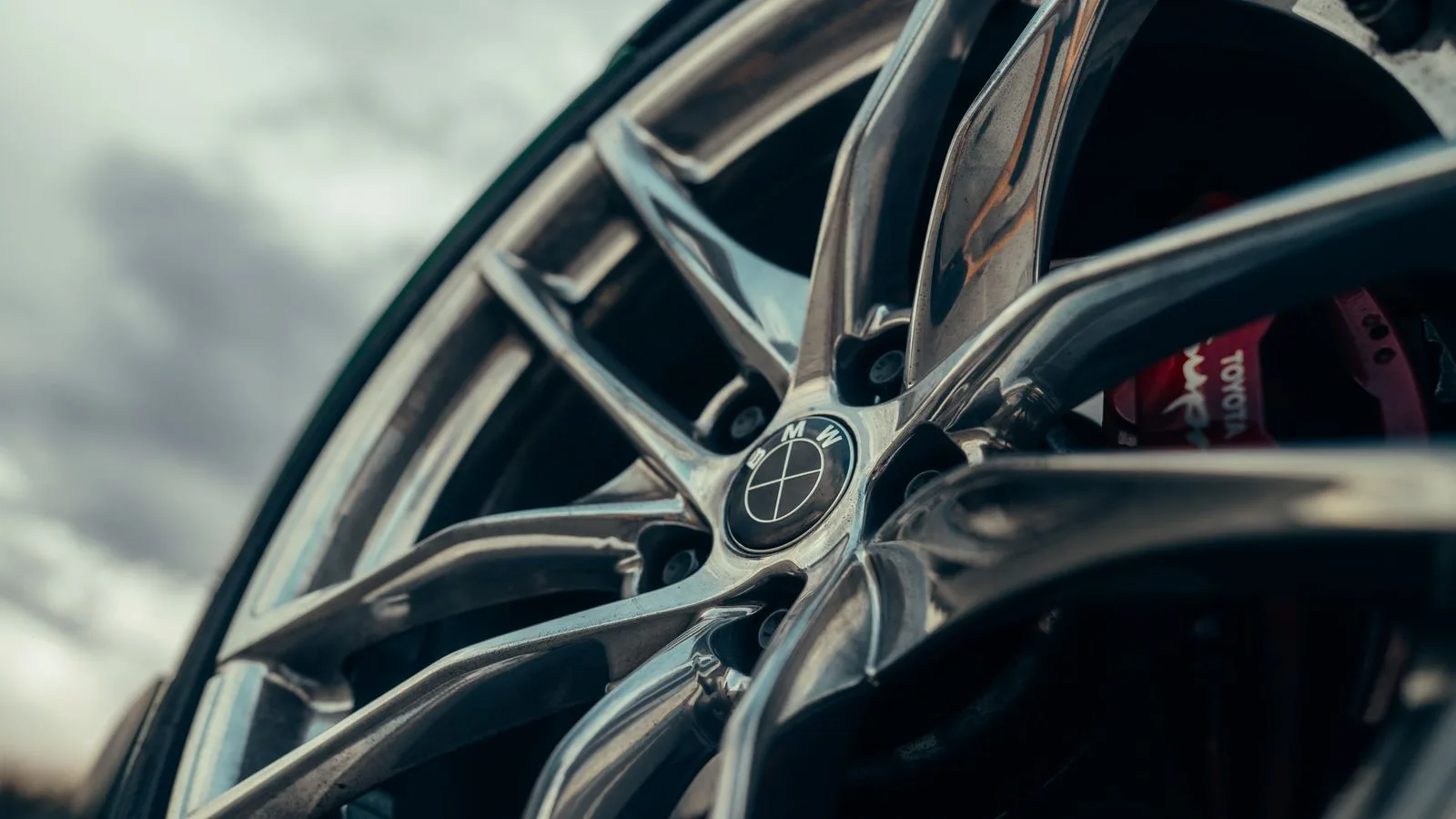 Detailed image of a car alloy wheel, showcasing modern design with sharp lines and sleek appearance.