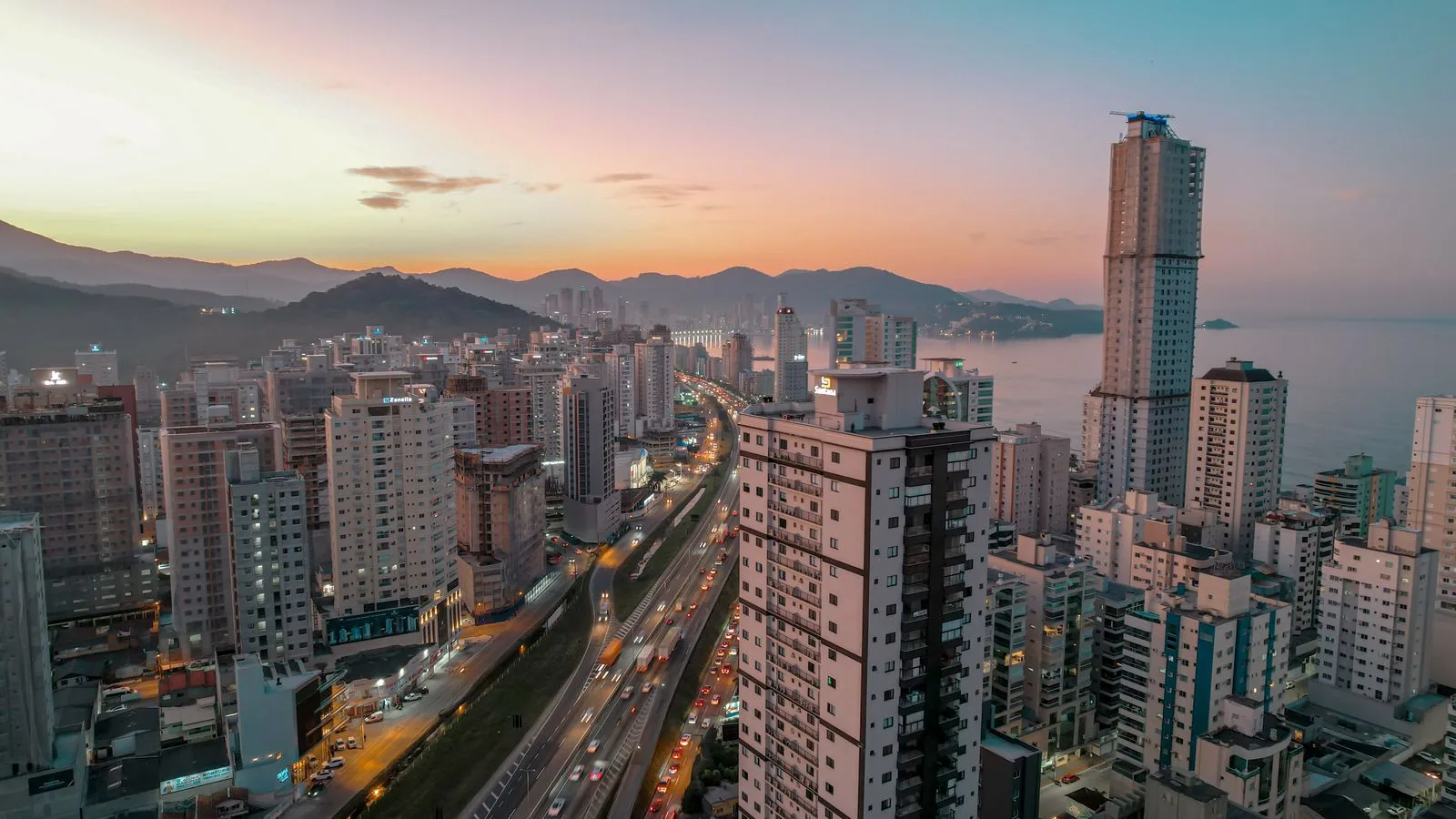 Aerial view of Itapema, Santa Catarina at sunset, showcasing the vibrant cityscape and coastline.