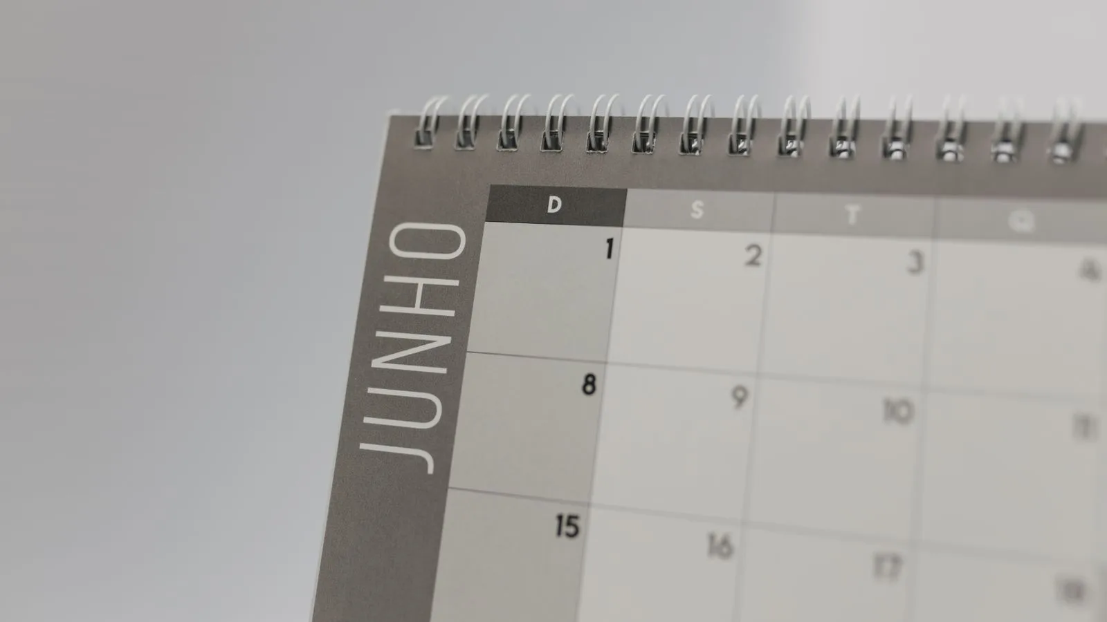 Close-up view of a spiral-bound calendar showing the month of June with a date grid.
