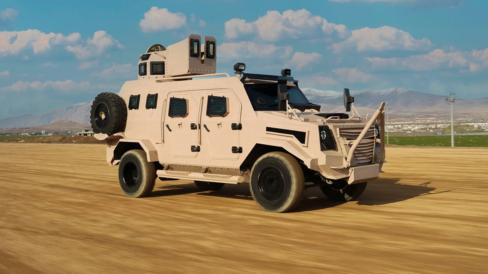 An armored military vehicle drives on a dirt road with mountain backdrop in Kurdistan.