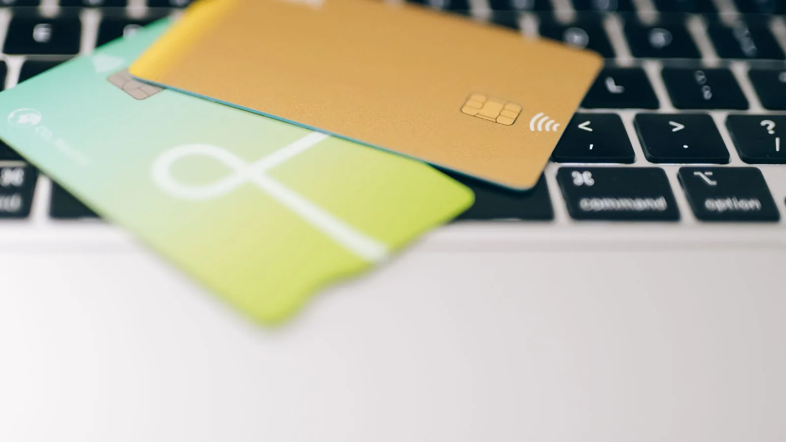 Two credit cards placed on a laptop keyboard highlighting online payment concept.