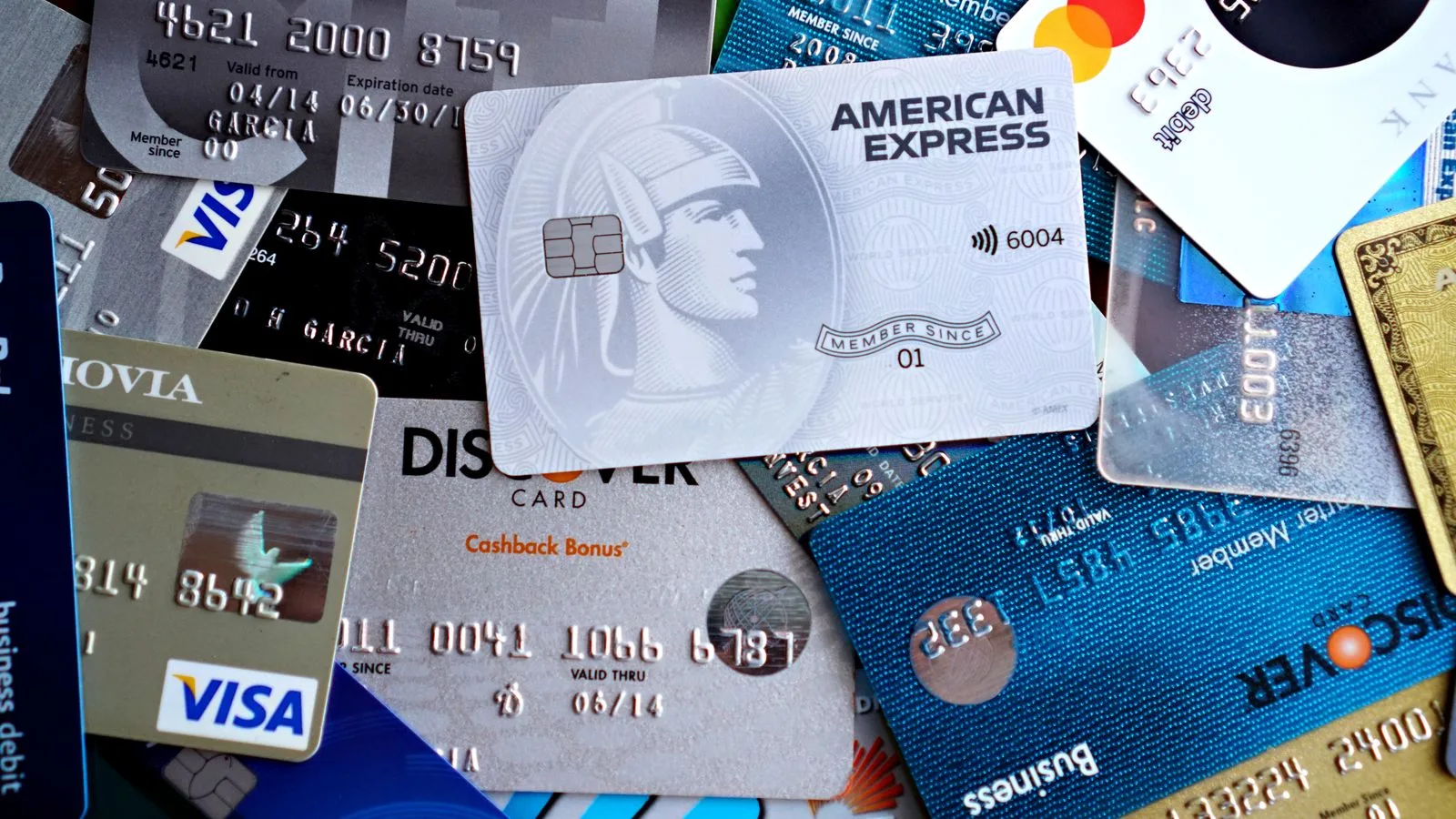 Close-up image of various credit and debit cards including Visa, MasterCard, American Express, and Discover.