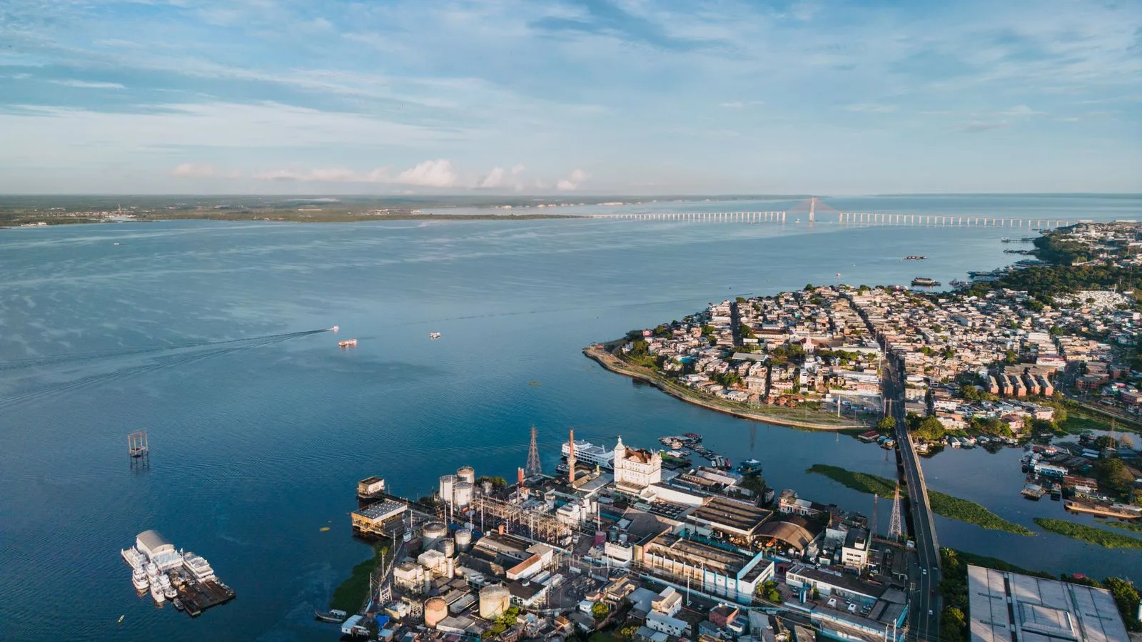 Stunning aerial view of Manaus, Brazil with Rio Negro Bridge in the distance.